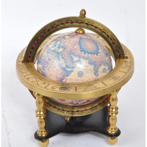 245 - A vintage 20th century desk top globe standing on metal supports finished with decorative brass plat... 