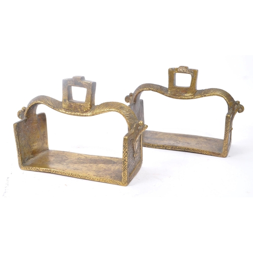 281 - A pair of 19th century brass Indian horse stirrups. Having a curved support arm with holes for ties.... 