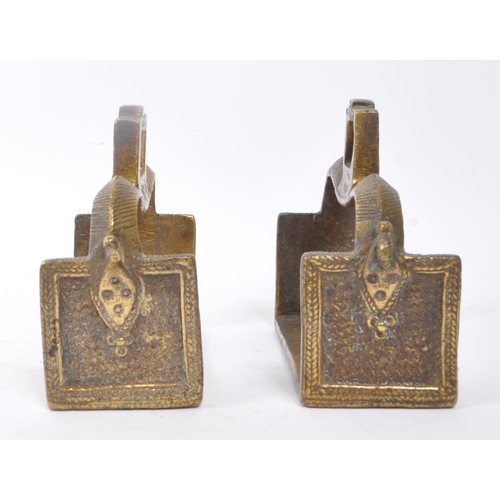 281 - A pair of 19th century brass Indian horse stirrups. Having a curved support arm with holes for ties.... 