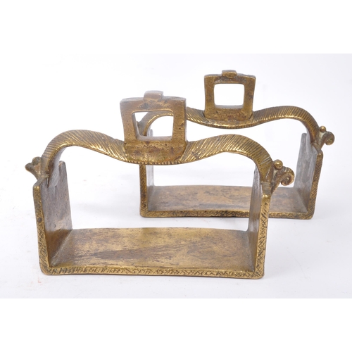 281 - A pair of 19th century brass Indian horse stirrups. Having a curved support arm with holes for ties.... 