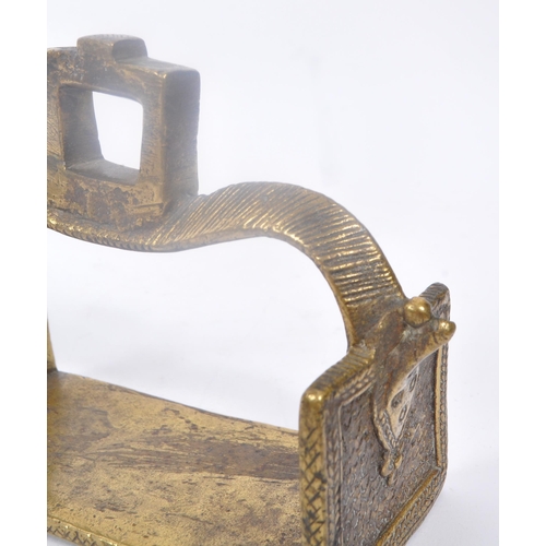 281 - A pair of 19th century brass Indian horse stirrups. Having a curved support arm with holes for ties.... 