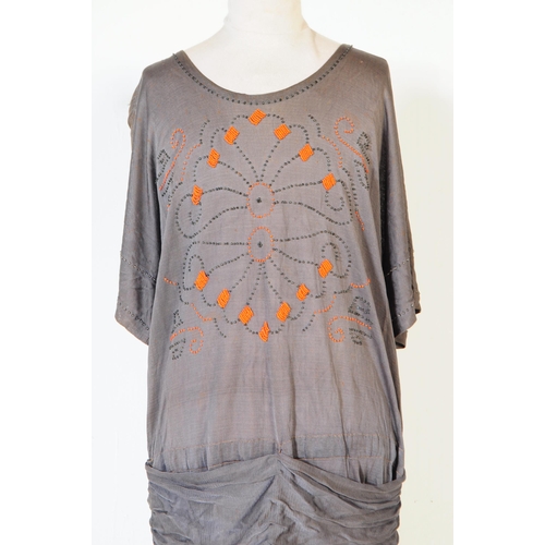 282 - A 1920s era Canadian beaded rayon dress in grey with vibrant orange beads decorating repeated patter... 