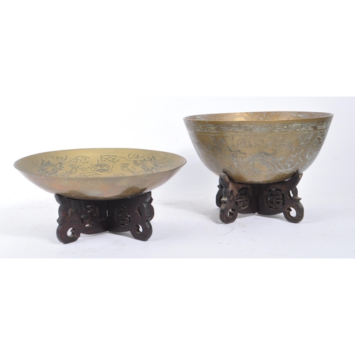 283 - A vintage 20th century Indian brass bowls with carved hardwood stands. Having carved phoenix figure ... 