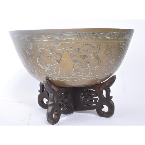 283 - A vintage 20th century Indian brass bowls with carved hardwood stands. Having carved phoenix figure ... 