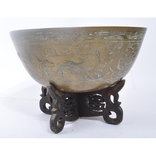 283 - A vintage 20th century Indian brass bowls with carved hardwood stands. Having carved phoenix figure ... 