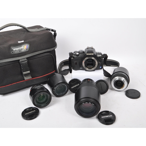 295 - Olympus - A contemporary Olympus E-410 four thirds system dSLR camera with lenses. The camera having... 