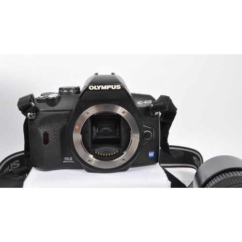 295 - Olympus - A contemporary Olympus E-410 four thirds system dSLR camera with lenses. The camera having... 