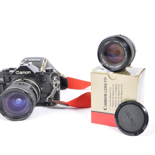 297 - Canon - A 20th century circa 1980s Canon A-1 35mm SLR camera and lenses. The camera in black leather... 