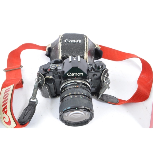 297 - Canon - A 20th century circa 1980s Canon A-1 35mm SLR camera and lenses. The camera in black leather... 