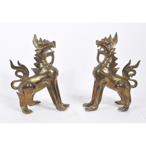 300 - Two 20th Century Burmese brass chinthe styled guardian dragons decorated with coloured stones. The f... 