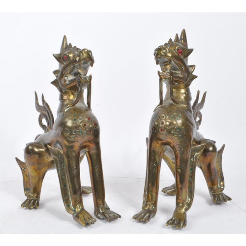 300 - Two 20th Century Burmese brass chinthe styled guardian dragons decorated with coloured stones. The f... 