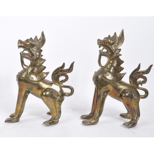 300 - Two 20th Century Burmese brass chinthe styled guardian dragons decorated with coloured stones. The f... 