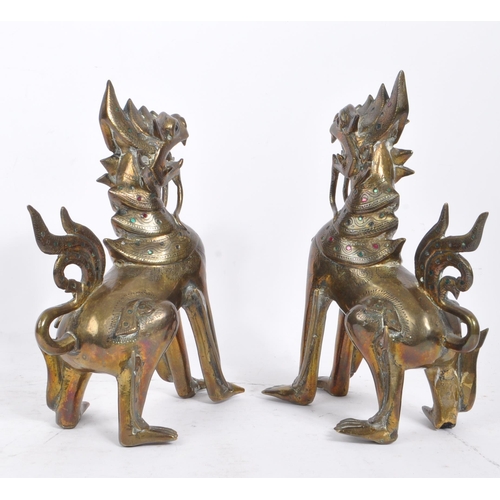 300 - Two 20th Century Burmese brass chinthe styled guardian dragons decorated with coloured stones. The f... 