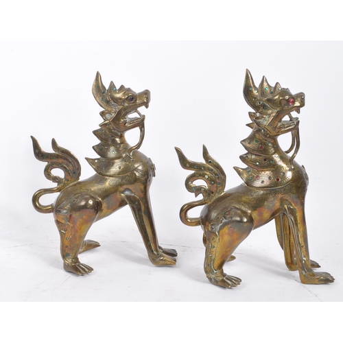 300 - Two 20th Century Burmese brass chinthe styled guardian dragons decorated with coloured stones. The f... 