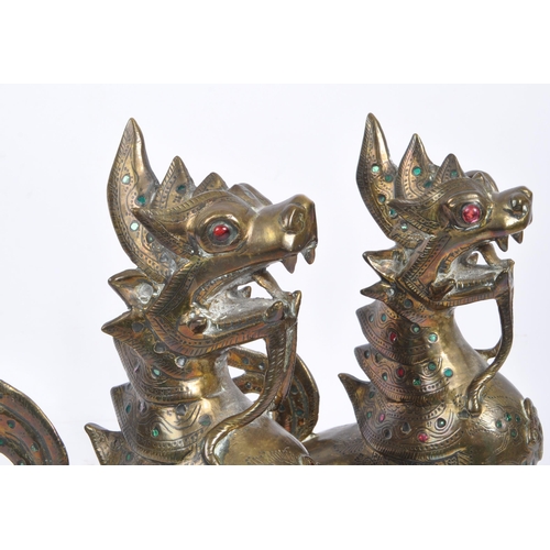 300 - Two 20th Century Burmese brass chinthe styled guardian dragons decorated with coloured stones. The f... 