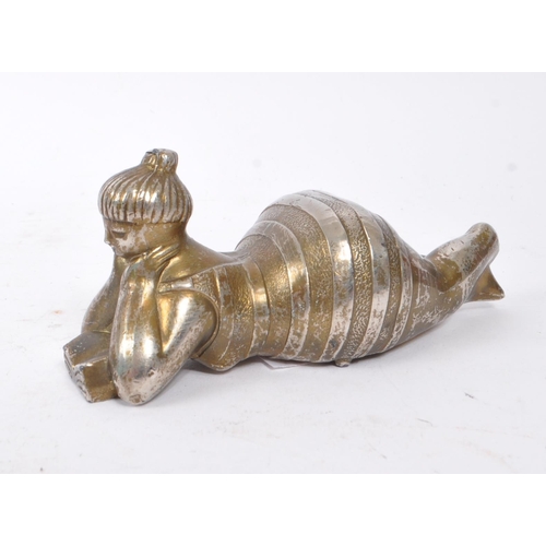 301 - A 20th Century novelty metal reclining bather bottle opener the figure wearing striped bathing suit ... 