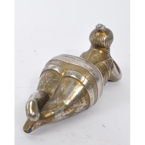 301 - A 20th Century novelty metal reclining bather bottle opener the figure wearing striped bathing suit ... 