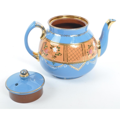 37 - Two hand decorated ceramic teapots, one by Wades. The teapots of blue and black colourways with hand... 