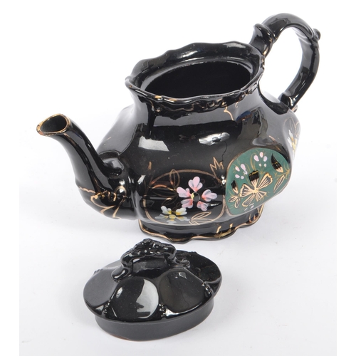 37 - Two hand decorated ceramic teapots, one by Wades. The teapots of blue and black colourways with hand... 