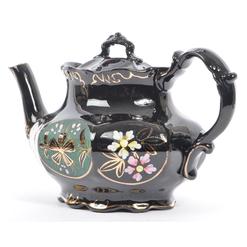 37 - Two hand decorated ceramic teapots, one by Wades. The teapots of blue and black colourways with hand... 