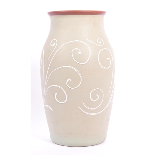 40 - A ceramic Denby stoneware vase. Sage green ground with raised white scrollwork detailing. Measures 3... 