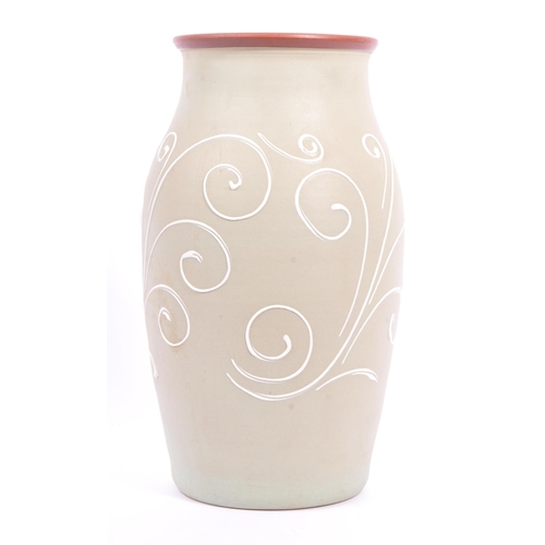 40 - A ceramic Denby stoneware vase. Sage green ground with raised white scrollwork detailing. Measures 3... 