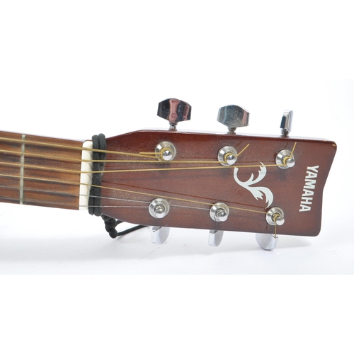 406 - A Yamaha F310 - Acoustic musical guitar instrument. With chrome tuners, label to inside. Cased. Meas... 