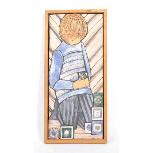 47 - A vintage 1970s ceramic wall plaque by Sheila Stapleton. Plaque depicting a young girl picking styli... 