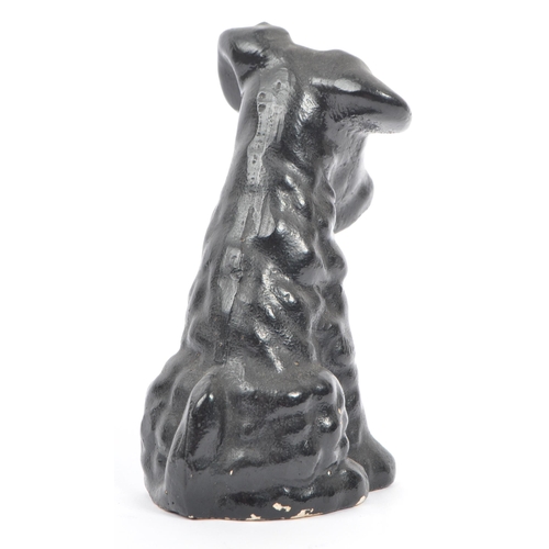 54 - A fine bone ceramic china & ceramic seated terrier dog animal figurine. In a black colourway / red t... 