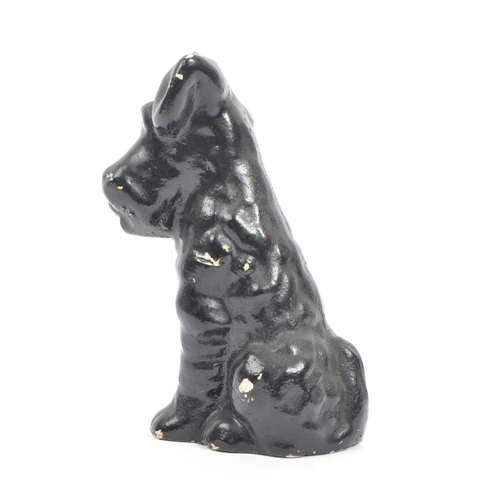 54 - A fine bone ceramic china & ceramic seated terrier dog animal figurine. In a black colourway / red t... 