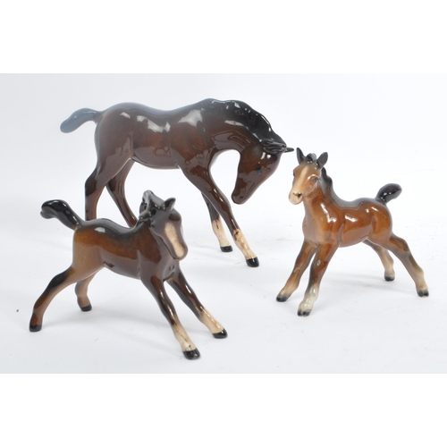 73 - Beswick - A collection of Beswick porcelain horse figurines to include five brown examples. Stamped ... 