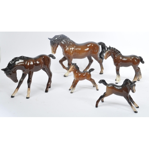 73 - Beswick - A collection of Beswick porcelain horse figurines to include five brown examples. Stamped ... 