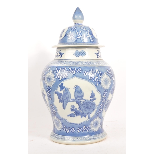 75 - A large 20th Century chinese porcelain china hand painted blue and white lidded vase / jar depicting... 