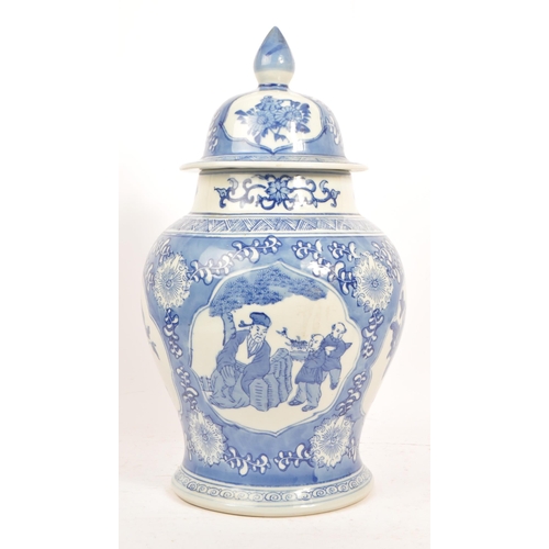 75 - A large 20th Century chinese porcelain china hand painted blue and white lidded vase / jar depicting... 