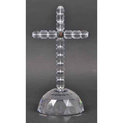 81 - Swarovski - A boxed Swarovski cross of light decorative ornament. The ornament in the form of a cruc... 