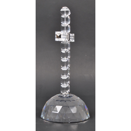 81 - Swarovski - A boxed Swarovski cross of light decorative ornament. The ornament in the form of a cruc... 