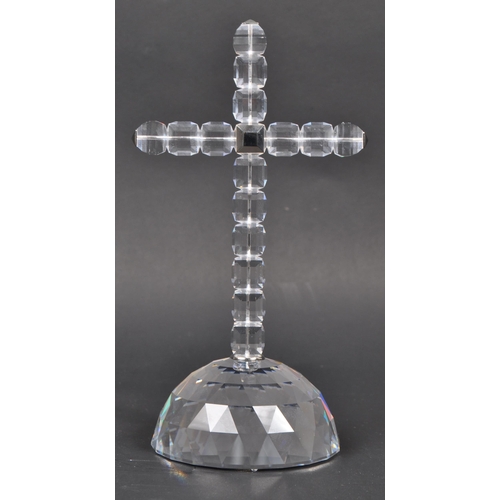 81 - Swarovski - A boxed Swarovski cross of light decorative ornament. The ornament in the form of a cruc... 