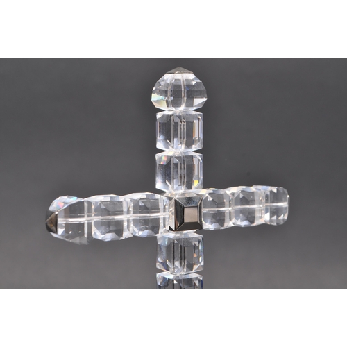 81 - Swarovski - A boxed Swarovski cross of light decorative ornament. The ornament in the form of a cruc... 