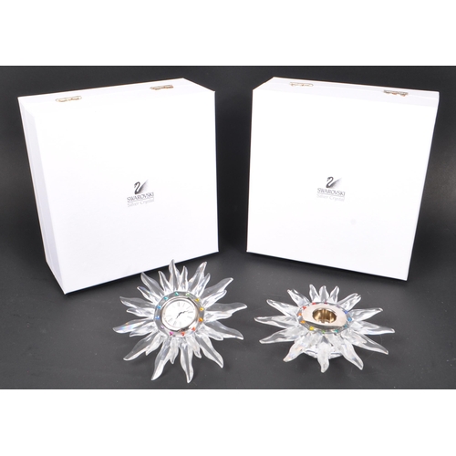 82 - Swarovski - Two boxed Swarovski crystal Solaris decorative table pieces. To include a Swarovski cand... 