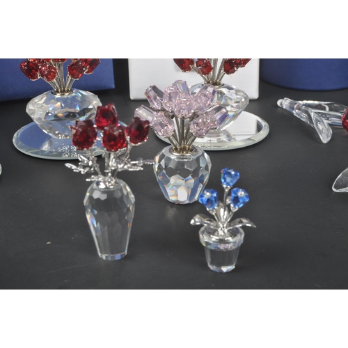 89 - Swarovski - A collection of Swarovski crystal decorative floral figures / ornaments. The collection ... 