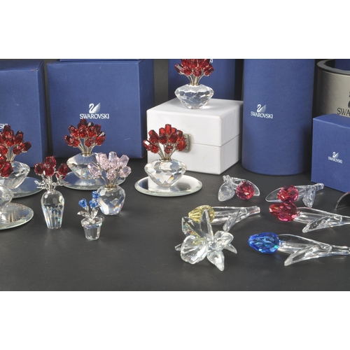 89 - Swarovski - A collection of Swarovski crystal decorative floral figures / ornaments. The collection ... 