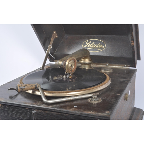 413 - Selecta - An early 20th century Art Deco oak gramophone / record player. Having an oak case with hin... 