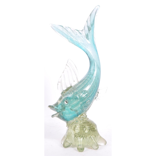 131 - A mid 20th century Murano studio art glass fish. The fish resting atop a glass form in the manner of... 