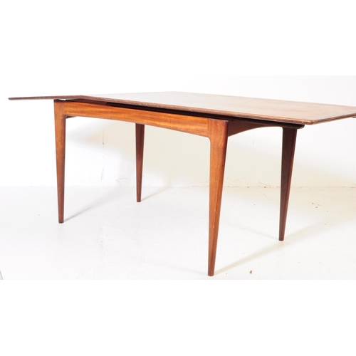 550 - A retro 20th century Danish influenced teak extending dining table. The table having a round rectang... 