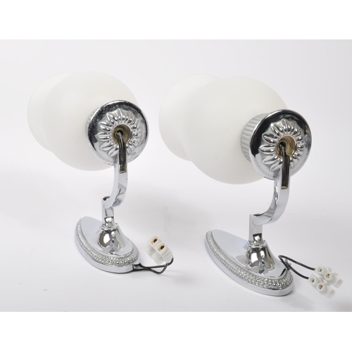 556 - A pair of Art Deco-style frosted glass sconces / wall lamps mounted on removable stainless steel met... 