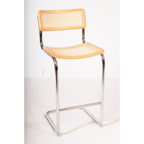 576 - Manner of Habitat - A pair of 20th century chrome and rattan weave cantilever bar stools in the mann... 