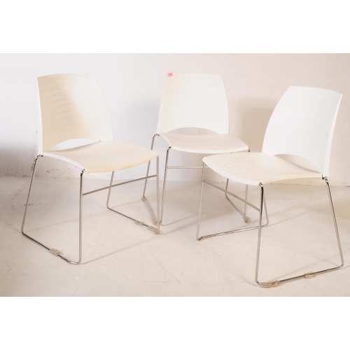 586 - Frovi - A set of three mid 20th century canteen / bistro / café dining chairs. Having moulded white ... 