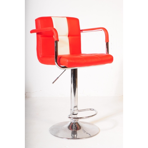 607 - A pair of mid 20th century circa 1970s red and white vinyl and chrome bar stool chairs. The chair ha... 