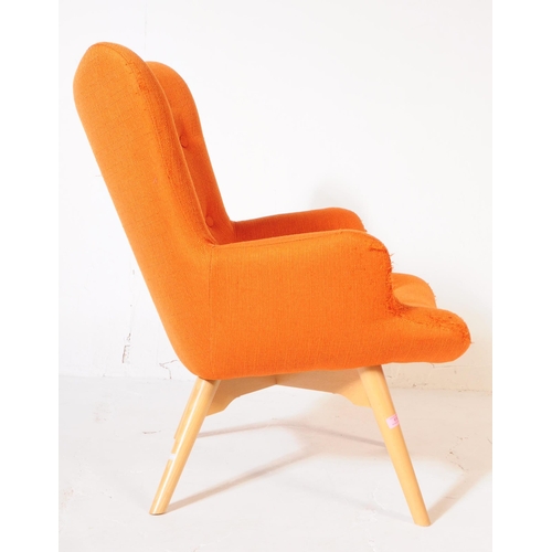 610 - A mid 20th century wingback armchair in the manner of Ercol 236 tub chair. The chair having wing bac... 