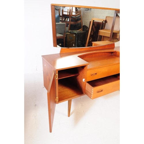 611 - Lebus - A mid 20th century Lebus teak wood dressing table. The dresser of inverse breakfront form, w... 